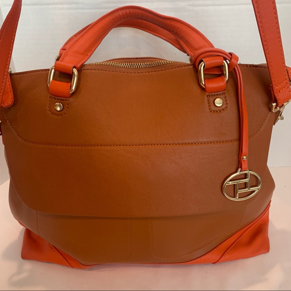 Orange handbag with a rust color body of bag and orange accent shoulder strap